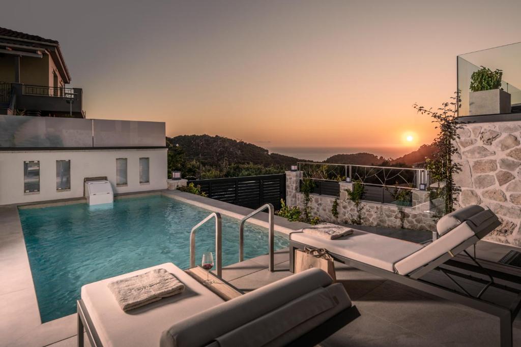 a villa with a swimming pool and a sunset at Sunset Dream Luxury Villa in Keri