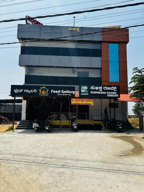 a building with motorcycles parked in front of it at Subhiksha Rooms in Bellūru