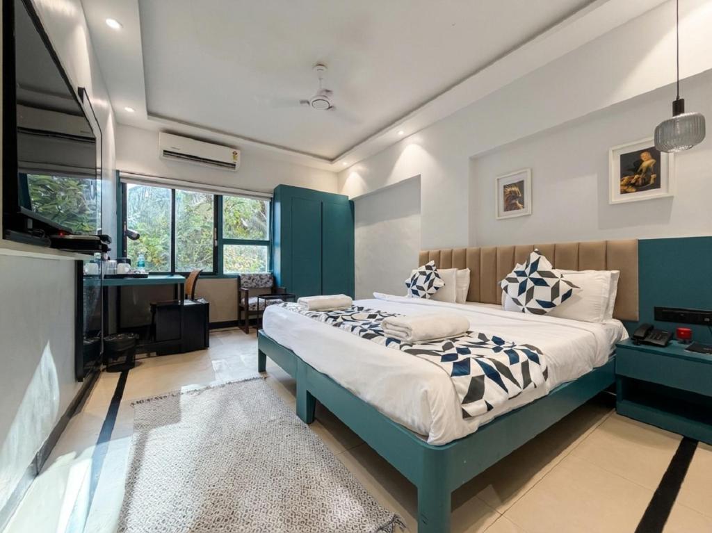 a bedroom with a large bed and a fireplace at asar Elite by Orion Hotels in Mumbai