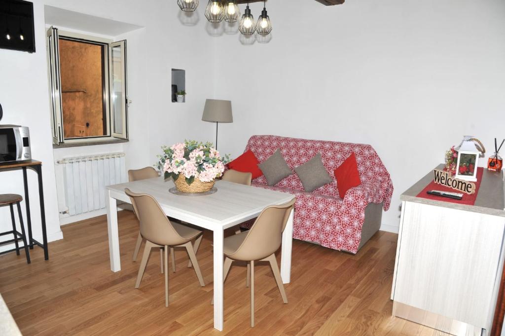 a kitchen and living room with a table and a couch at Il Valentino in Castel Gandolfo
