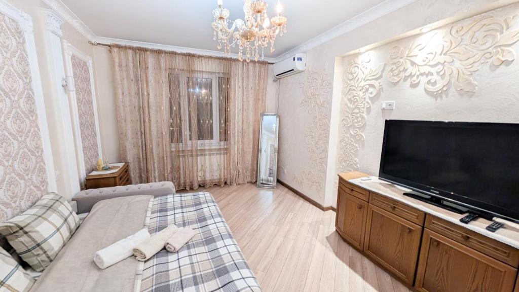 a living room with a large flat screen tv at Airport Transit Studio Ночь перед вылетом in Chişinău