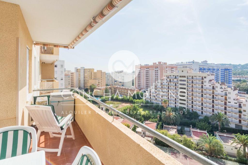 a balcony with chairs and a view of the city at Señorio de Oropesa-CM in Oropesa del Mar