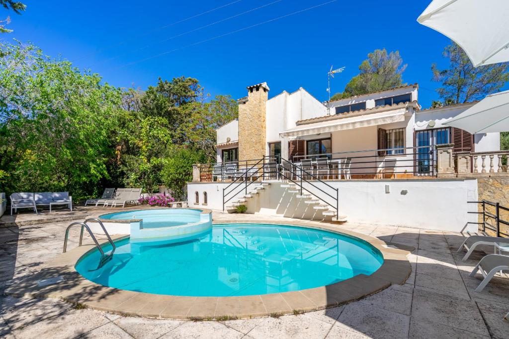 a swimming pool in the backyard of a house at Bon Jardi in Esporlas