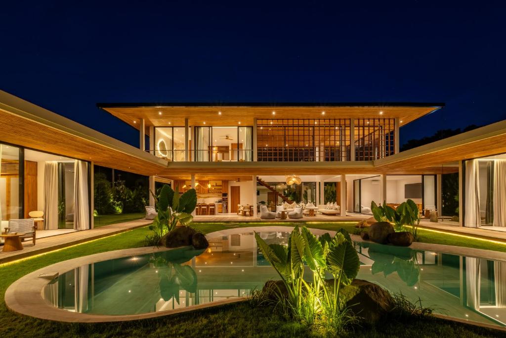 an exterior view of a house with a swimming pool at Uluwatu Zen Villas in Badung