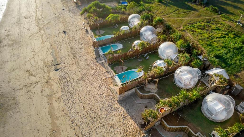 an aerial view of a resort with domes in the water at Bubble 1 - Romantic Private Pool Love Dome Uluwatu in Uluwatu