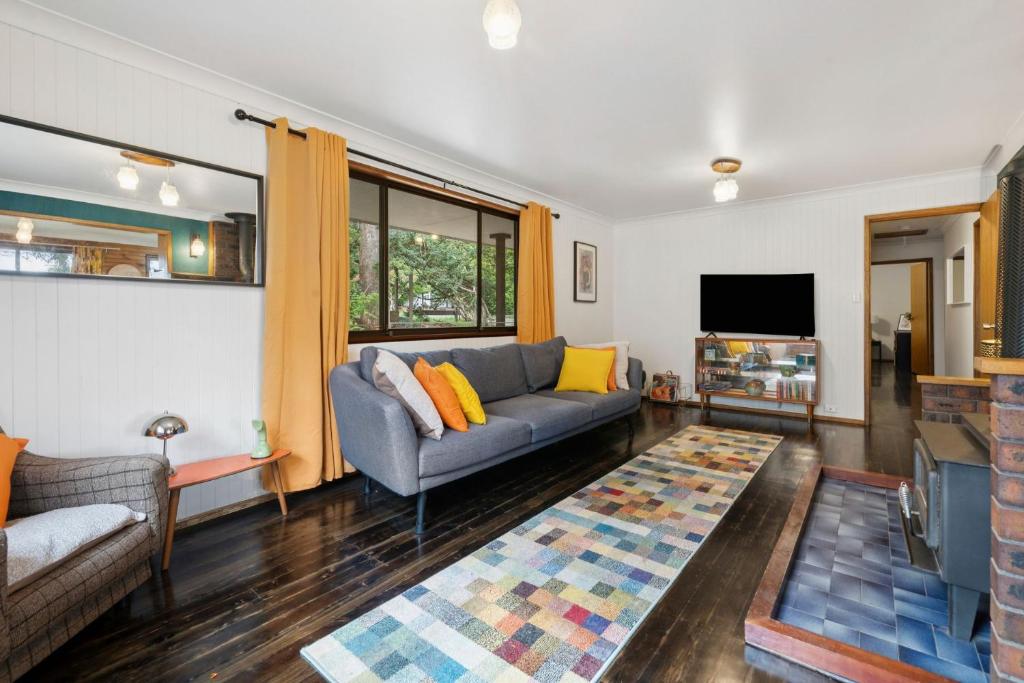 a living room with a couch and a tv at Lady Marmalade in Blackheath
