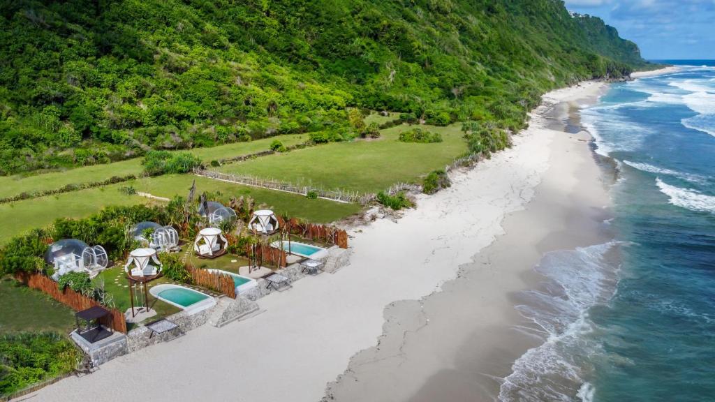 an aerial view of a resort on the beach at Bubble 2 - Sunset Private Pool Dome Uluwatu in Uluwatu