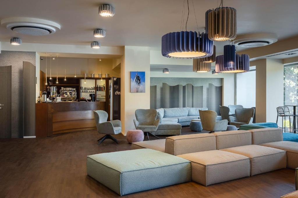 a living room with a couch and chairs at Hotel Castello in LʼAquila
