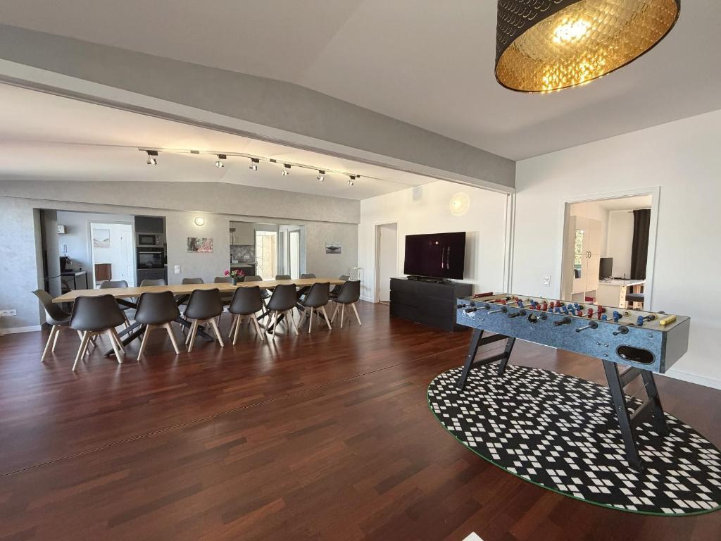 a large living room with a table and chairs at Cityscape Loft Hannover - 216qm 15 Personen in Hannover