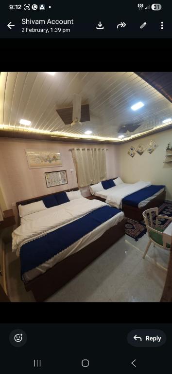 a bedroom with two beds in a room at ROOMS vala in Varanasi
