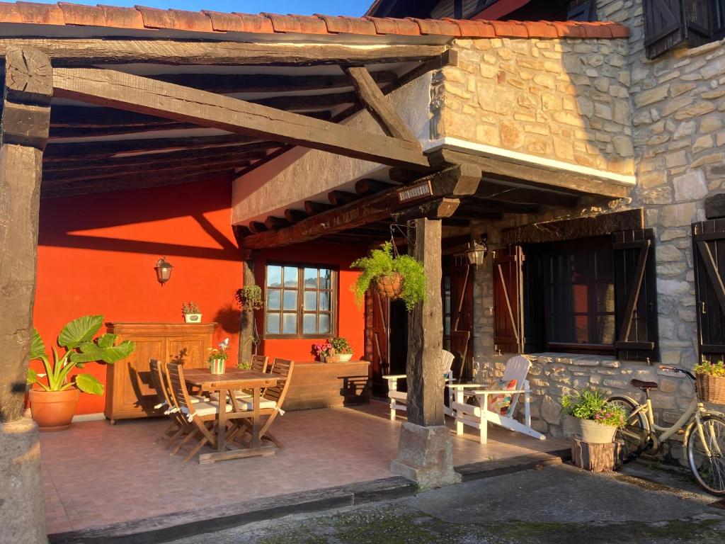 a patio with a table and chairs next to a building at Lekunberri Baserria in Arrieta
