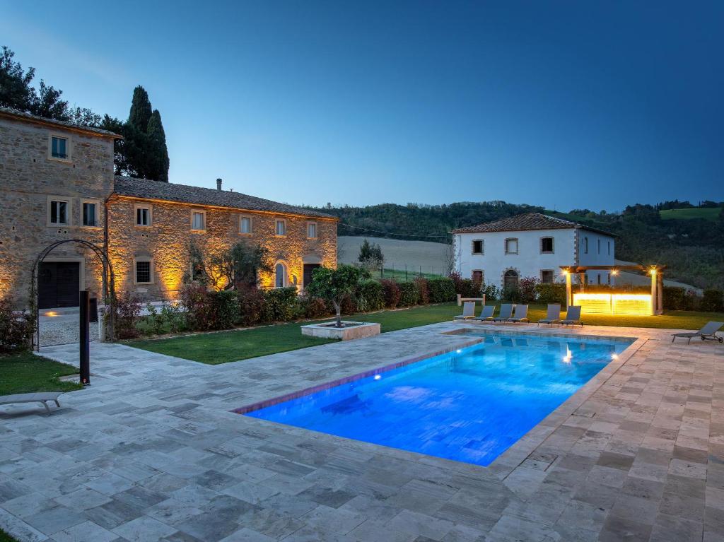 a swimming pool in the backyard of a house at Borgo Ariano near Volterra by PosarelliVillas in Volterra