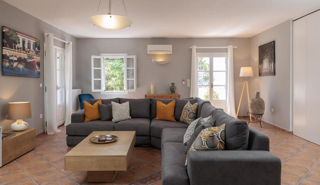 a living room with a couch and a table at Villa Kairos Naxos in Glinádhon