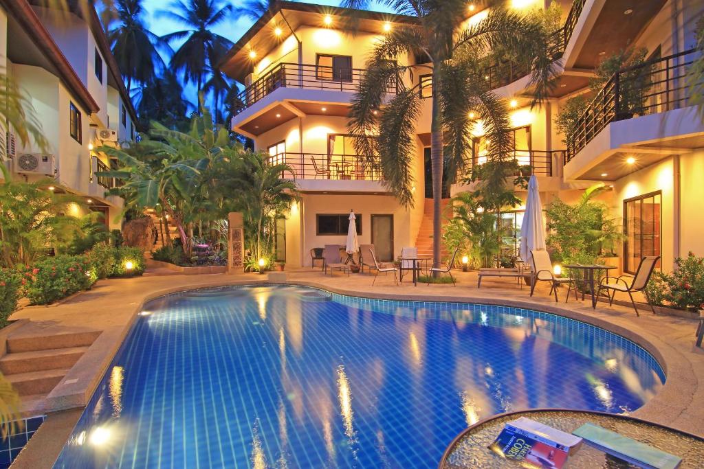 a swimming pool in front of a building at Soleil D'asie Residence in Chaweng Noi Beach