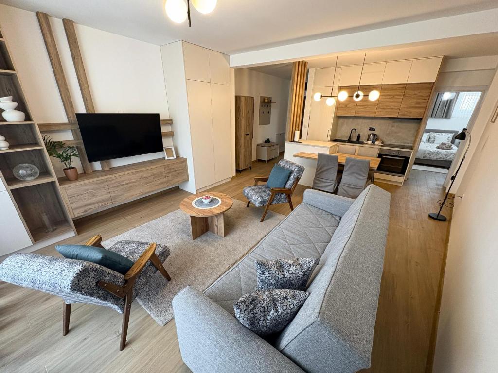 a living room with a couch and a tv at Apartman Jančić in Loznica