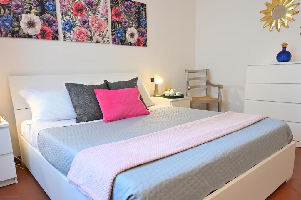 a bedroom with a large bed with colorful pillows at Casa Garibaldi con Terrazzo e Parking, Mare 1 min in San Vincenzo