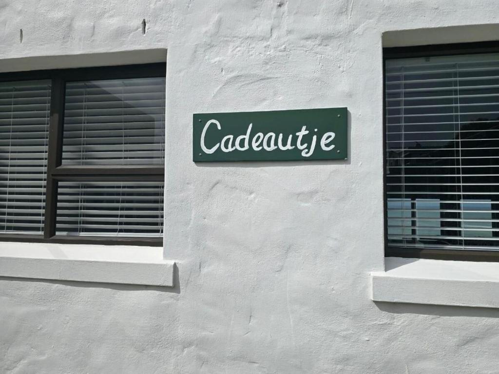 a green sign on the side of a building at Ocean View Drive 150 in Struisbaai