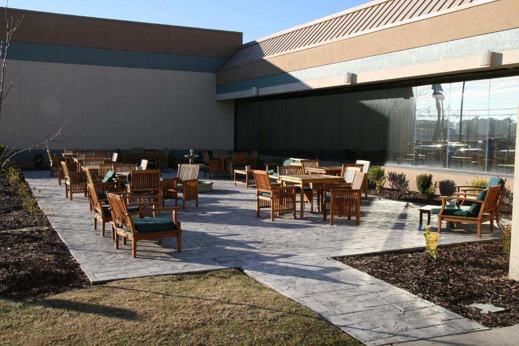 a patio with tables and chairs in front of a building at DoubleTree by Hilton Hotel Augusta in Augusta