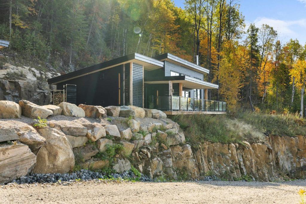 a house on a hill with a stone wall at Spa & Panoramic Nature Views - Alto in Saint Come
