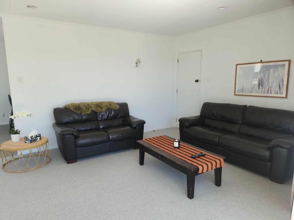 a living room with a couch and a coffee table at 3 bedroom hidden gem in Gore