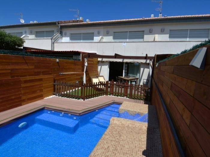 a swimming pool in front of a house at Casa Rosalia in Roda de Bará