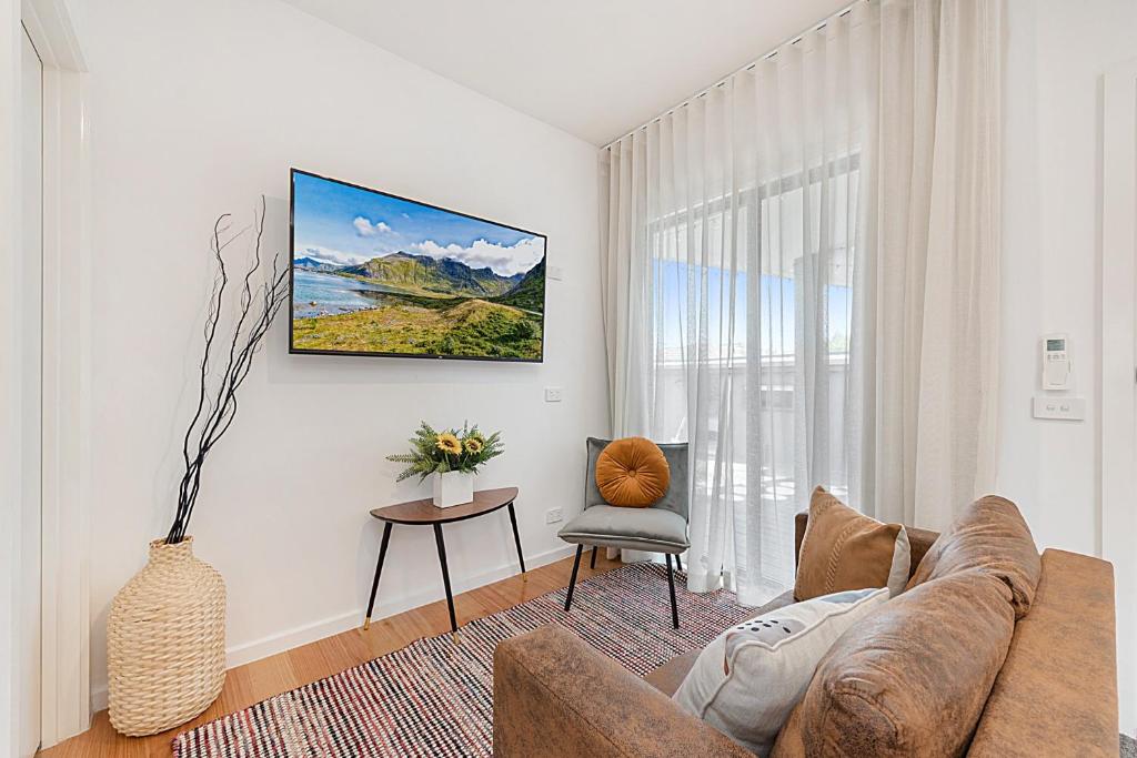a living room with a couch and a chair at Gorgeous 3-Bed House with Spacious Shared Backyard in Carnegie