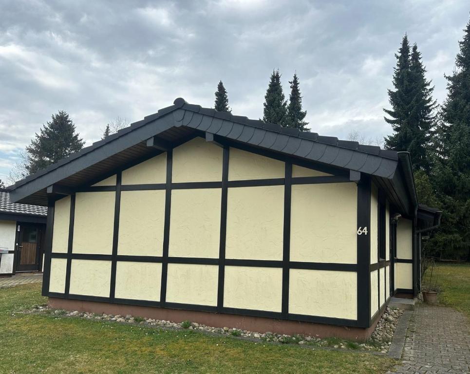 a building with a black and white garage at Ferienhaus Morgentau in Waldbrunn