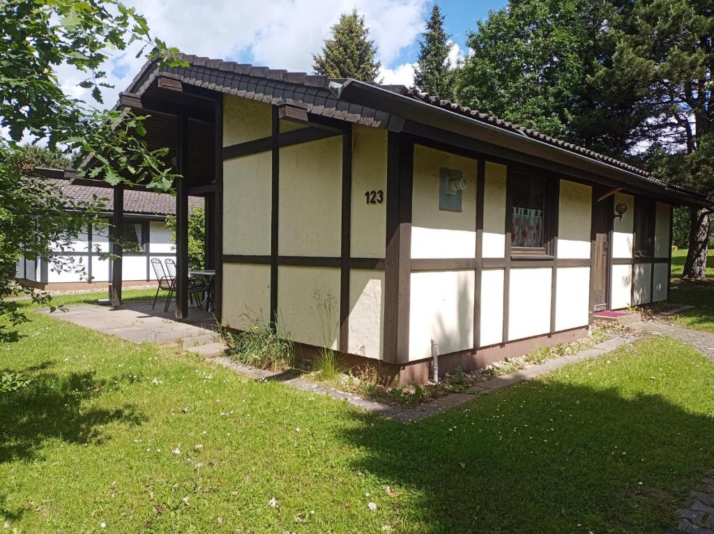 a small house with white and black paint on it at Ferienhaus Abendstille in Waldbrunn