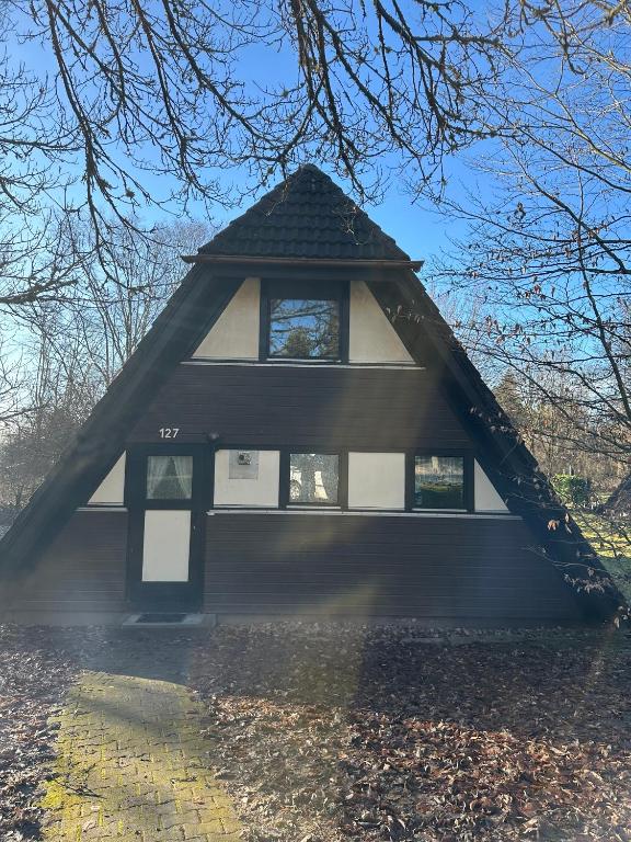 a house with a gambrel roof with windows at Ferienhaus Abendzauber in Waldbrunn