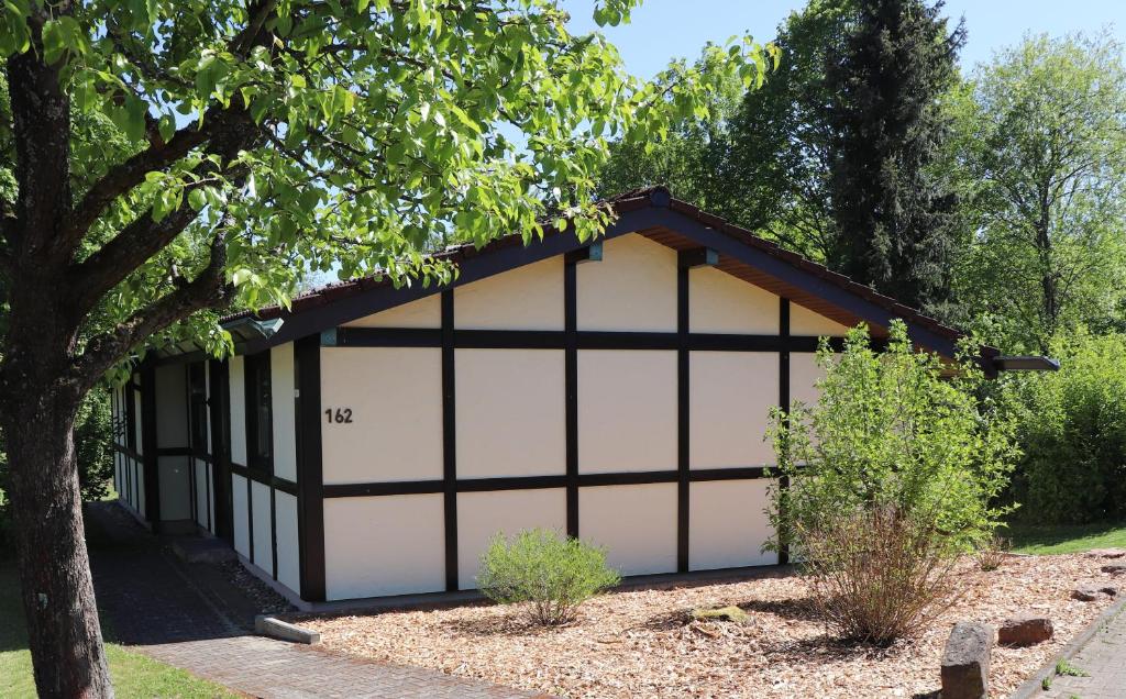 a garage with a black and white building at Ferienhaus Urlaubsfreude in Waldbrunn