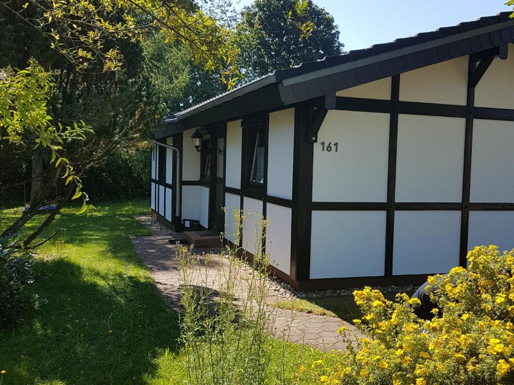 a building with two garage doors in a yard at Ferienhaus Gartenglück in Waldbrunn