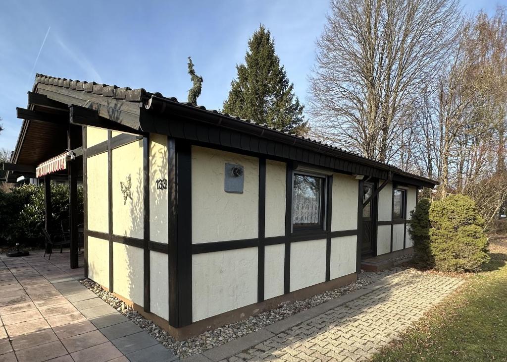 a small house with a black and white exterior at Ferienhaus Sonnenpfad in Waldbrunn