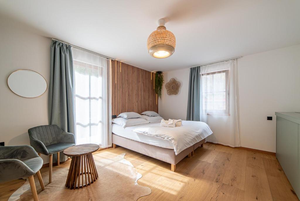 a bedroom with a bed and a chair at Hamr Divci Kamen in Křemže