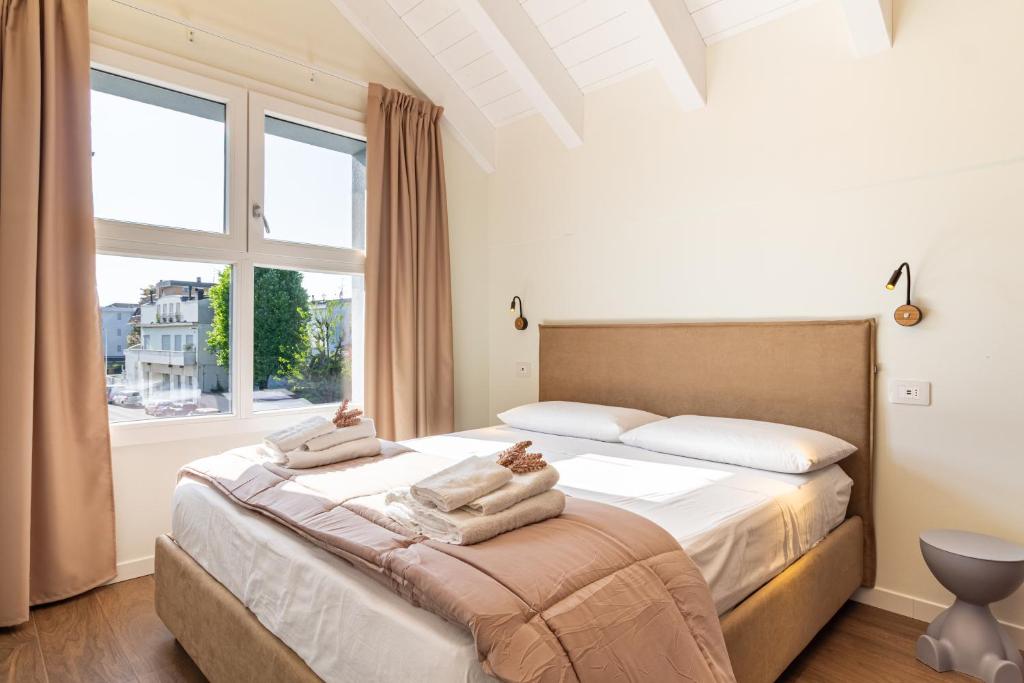 a bedroom with a large bed with a window at Nobel Flower Apartments in Lissone
