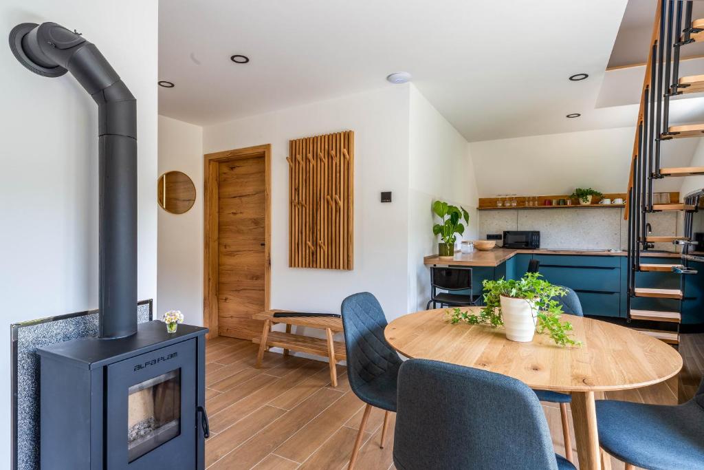 a living room with a wood stove and a table at Alpine Daffodil Retreat in Jesenice