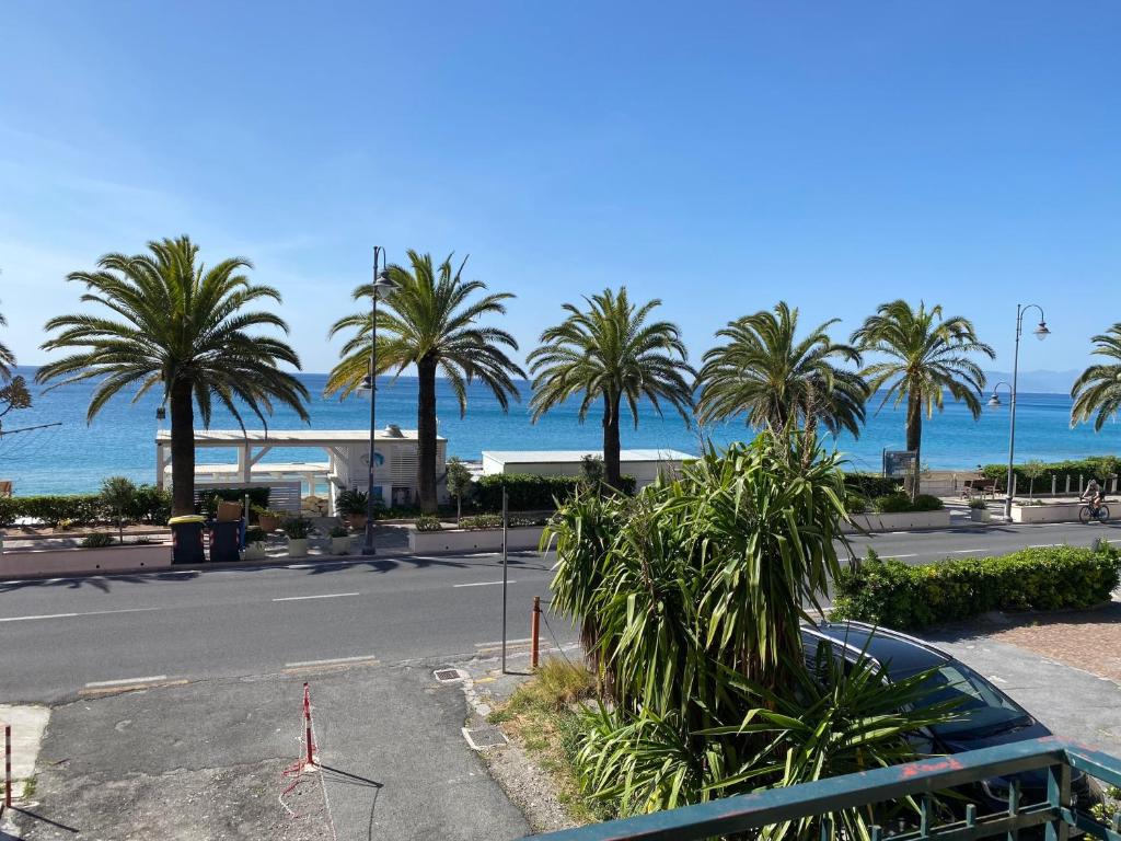 a parking lot with palm trees and the ocean at Welcome Varigotti - Solemare in Varigotti