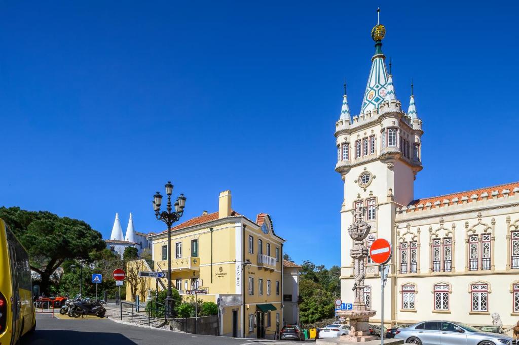 a large building with a clock tower on a street at Casa Mariana 2 - Sintra, Apartment in Sintra