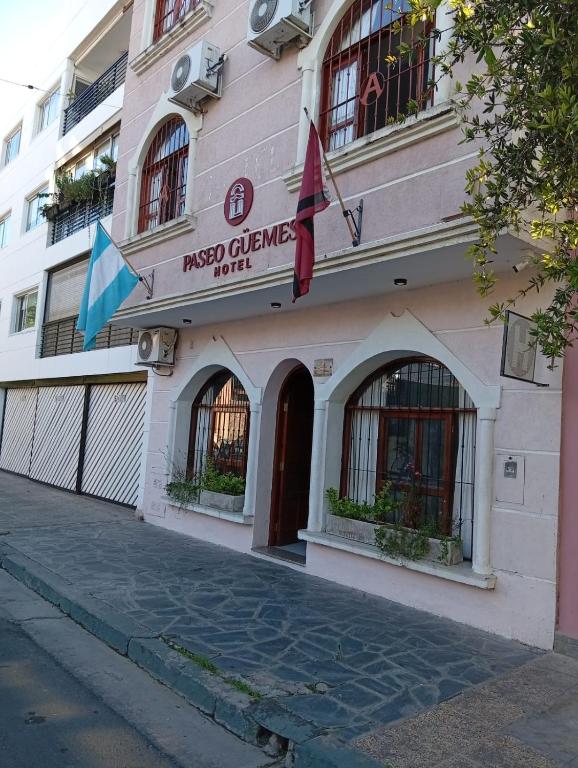 a building with a sign for the first climes hotel at PASEO GüEMES HOTEL in Salta