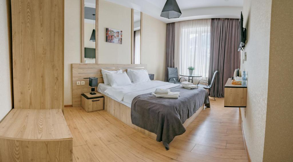 a hotel room with a bed and a table at City Heart Hotel in Tbilisi City