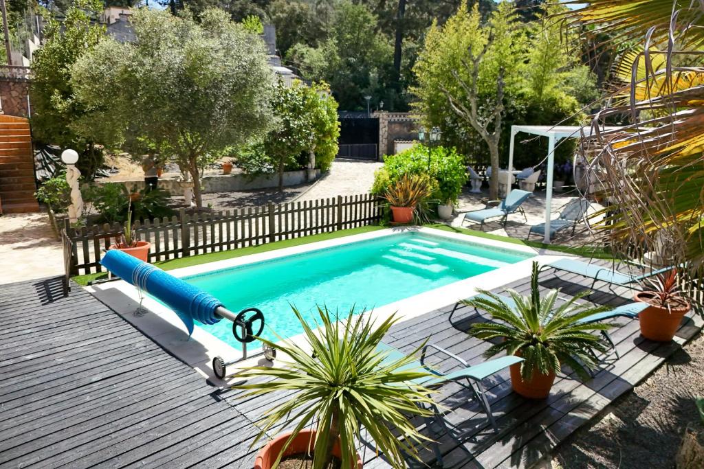 a pool with a blue slide in a yard at Villa Aphrodite in Puigventos