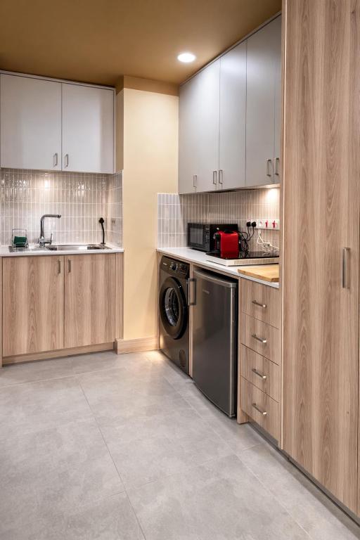 a kitchen with a washing machine and a sink at Top Location Studios - Avra, Boreio and Kyma in Larnaca