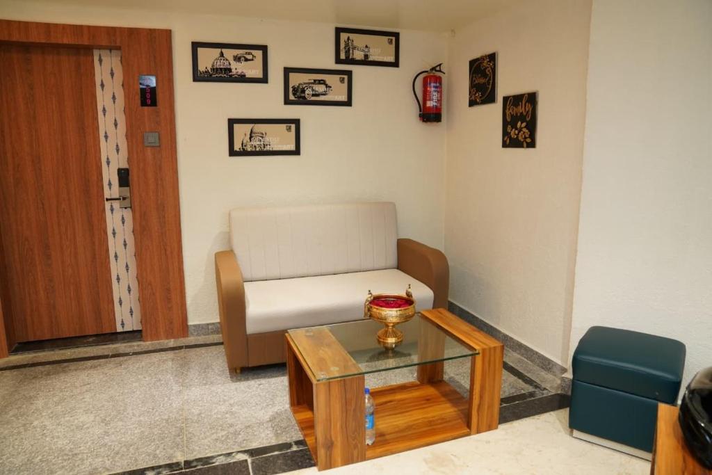 a living room with a couch and a table at Hotel Kama, Patna in Patna