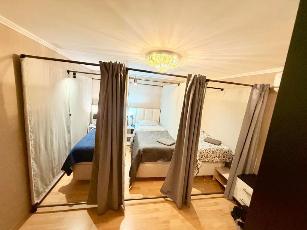 a bedroom with a bed and a large mirror at Новый Хостел с Кабинками in Chişinău