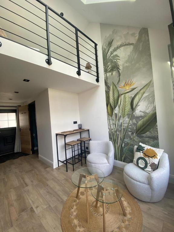 a living room with a couch and a table at L'atelier Maillot in Évreux