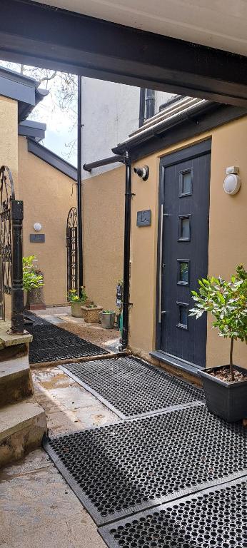an entrance to a house with a black door at Ground Floor Apartment, Garden and free parking - 10 The Rise in Kirkstall