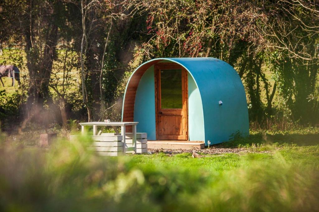 a blue dome tent with a door in a field at Daisy in Battle