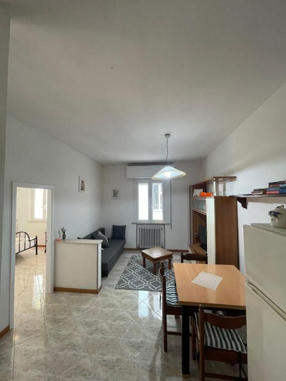 a kitchen and a living room with a table at Casa Bice in Misano Adriatico
