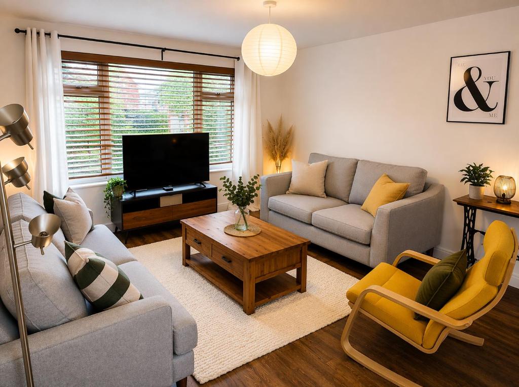 a living room with two couches and a television at Westbrook Spacious 3 Bed in Exeter in Pinhoe