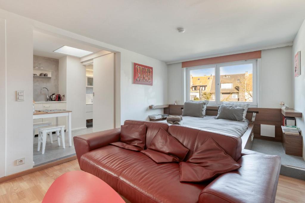 a living room with a couch and a bed at SleutelVan8 in Knokke-Heist