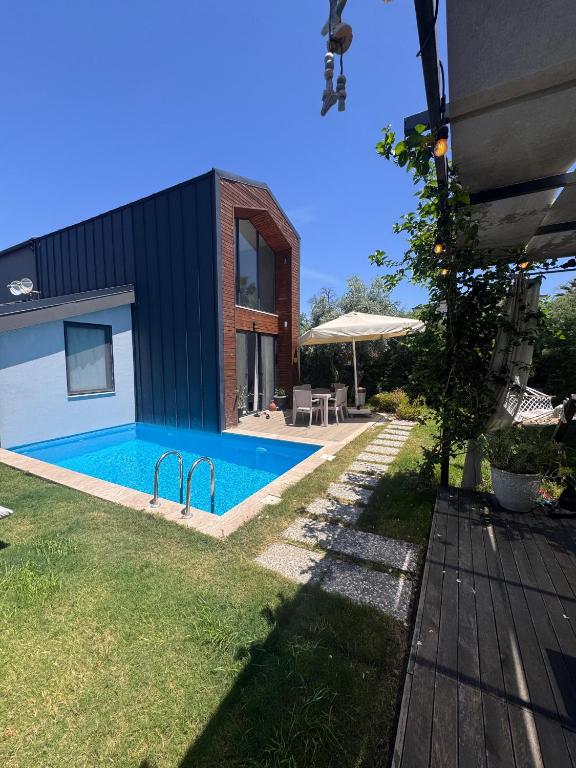 a swimming pool in the backyard of a house at Villa Rüzgar in Dalaman